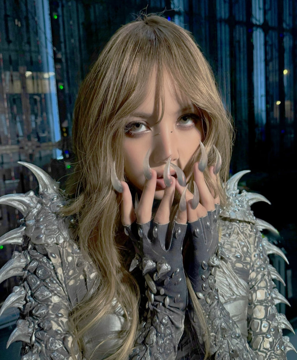 Person wearing a detailed costume with dragon-like features in an urban setting